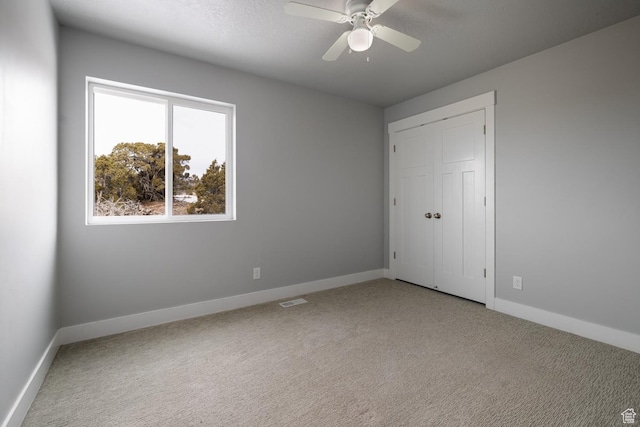 46501 W Bandanna Dr, Fruitland, UT 84027 - unfurnished bedroom featuring light carpet, visible vents, ceiling fan, and baseboards