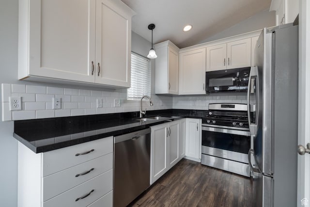 46501 W Bandanna Dr, Fruitland, UT 84027 - kitchen with dark countertops, decorative backsplash, appliances with stainless steel finishes, white cabinets, and a sink