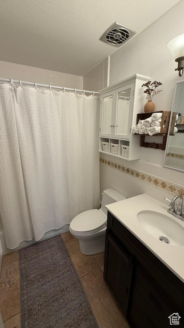 82 W 500 N, Vernal, UT 84078 - bathroom featuring tile patterned flooring, vanity, toilet, a textured ceiling, and visible vents