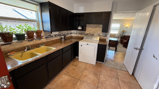 82 W 500 N, Vernal, UT 84078 - kitchen featuring a sink, dark cabinetry, washer / clothes dryer, light tile patterned floors, and decorative backsplash