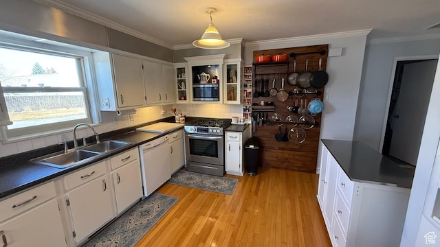 82 W 500 N, Vernal, UT 84078 - kitchen with crown molding, a sink, stainless steel appliances, and dark countertops