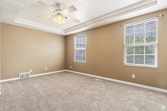 173 E Irisfield Dr S, Draper, UT 84020 - carpeted empty room with a raised ceiling, healthy amount of natural light, a ceiling fan, and baseboards