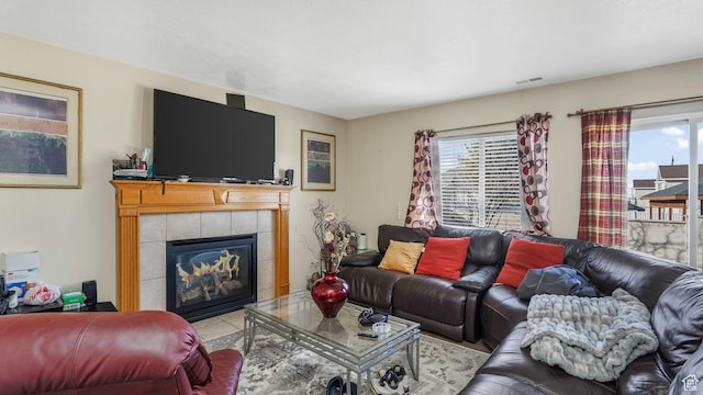 5254 W Ted Way, West Valley City, UT 84120 - living area with tile patterned floors, visible vents, plenty of natural light, and a fireplace
