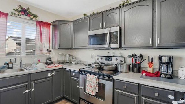 5254 W Ted Way, West Valley City, UT 84120 - kitchen featuring a sink, appliances with stainless steel finishes, gray cabinetry, and light countertops