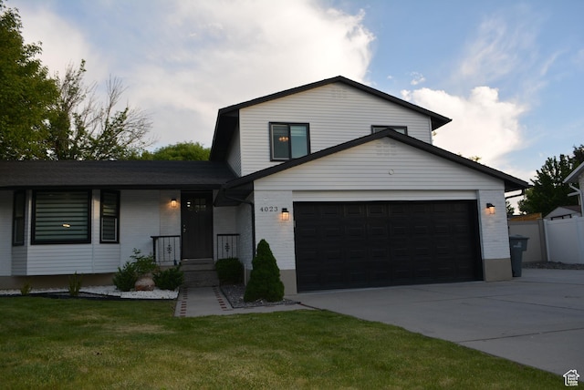 4023 W Severn Cir S, Jordan, UT 84009 - tri-level home with concrete driveway, a front yard, brick siding, and a garage