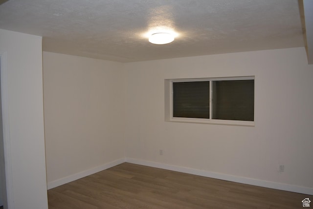 4023 W Severn Cir S, Jordan, UT 84009 - spare room featuring wood finished floors, baseboards, and a textured ceiling