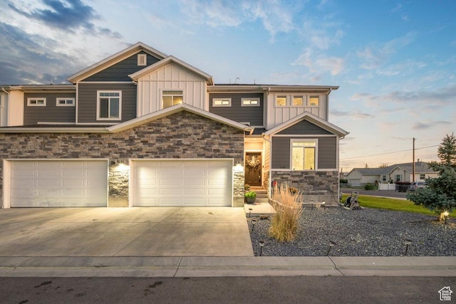 craftsman house with stone siding, board and batten siding, concrete driveway, and a garage
