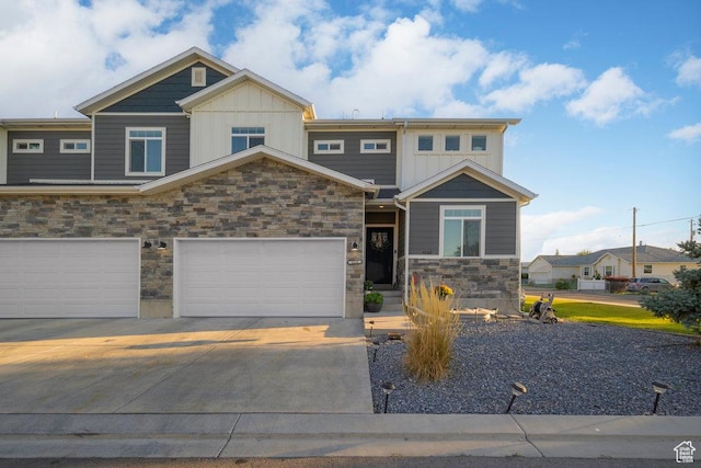 4268 S Steele Creek Ct E, Millcreek, UT 84107 - view of front of home featuring stone siding, board and batten siding, and concrete driveway