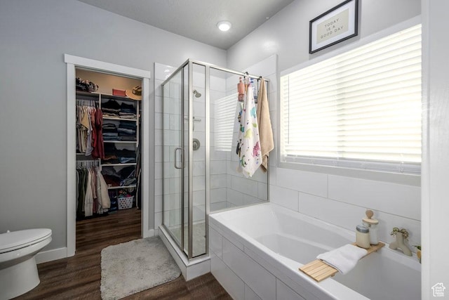 4268 S Steele Creek Ct E, Millcreek, UT 84107 - bathroom with a bath, a spacious closet, a shower stall, and toilet