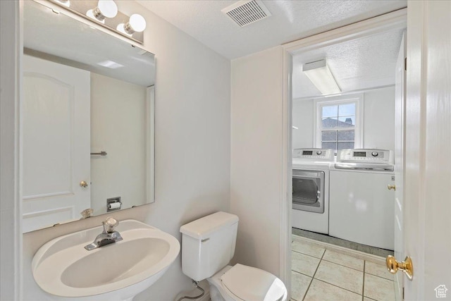 965 E 3400 N, Layton, UT 84040 - bathroom featuring visible vents, washing machine and dryer, toilet, tile patterned floors, and a sink