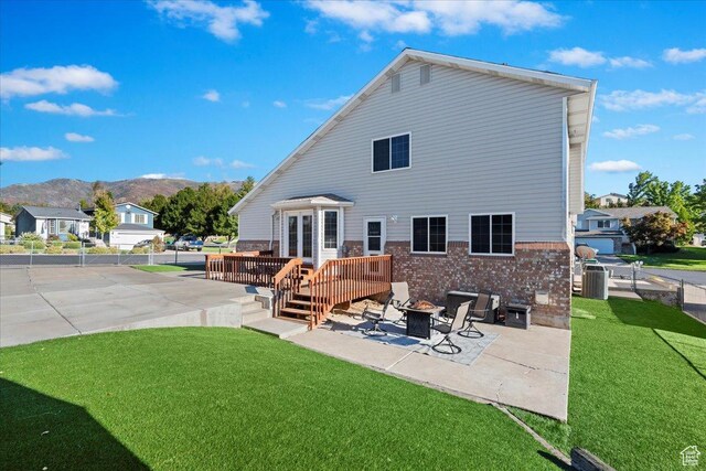 965 E 3400 N, Layton, UT 84040 - back of property with a yard, a patio, brick siding, and an outdoor fire pit