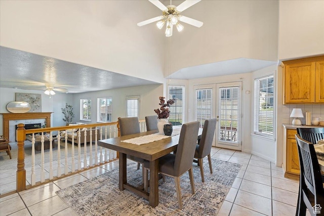 965 E 3400 N, Layton, UT 84040 - dining area with a fireplace, light tile patterned floors, a ceiling fan, and baseboards