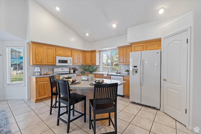 965 E 3400 N, Layton, UT 84040 - kitchen with a kitchen bar, white appliances, light tile patterned floors, and light countertops