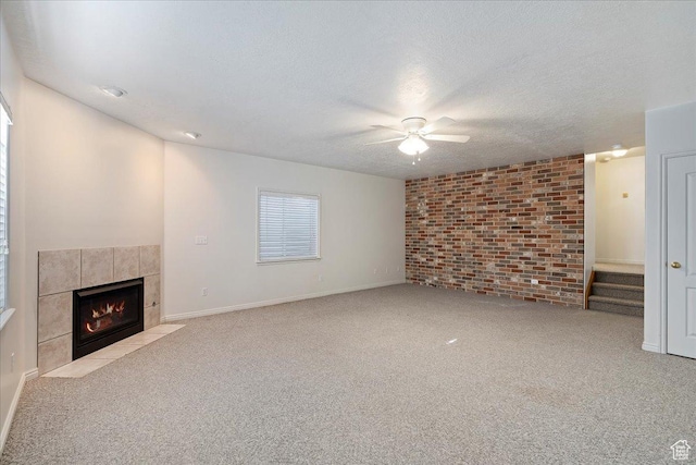 965 E 3400 N, Layton, UT 84040 - unfurnished living room with baseboards, a fireplace, ceiling fan, a textured ceiling, and carpet flooring
