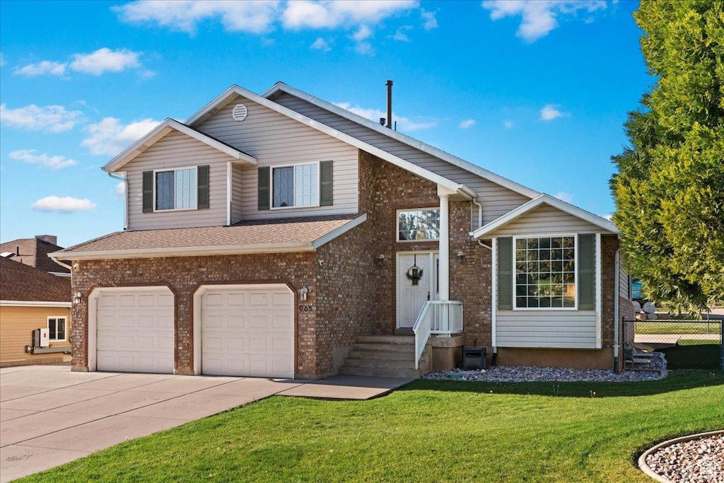 965 E 3400 N, Layton, UT 84040 - tri-level home featuring a front yard, an attached garage, fence, and driveway