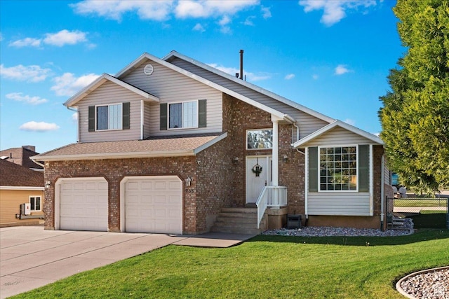 tri-level home featuring a front yard, an attached garage, fence, and driveway