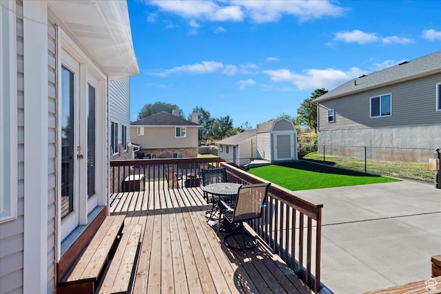 965 E 3400 N, Layton, UT 84040 - wooden deck featuring an outbuilding, fence, a patio area, a storage shed, and a lawn