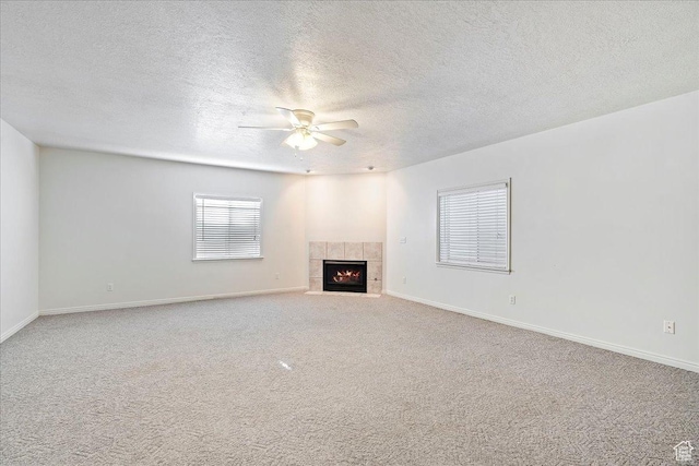 965 E 3400 N, Layton, UT 84040 - unfurnished living room featuring a ceiling fan, a textured ceiling, carpet floors, baseboards, and a tile fireplace