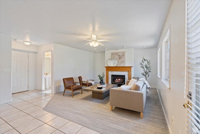 965 E 3400 N, Layton, UT 84040 - living room featuring light tile patterned floors, baseboards, a ceiling fan, and a fireplace