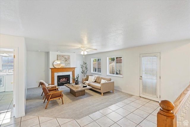 965 E 3400 N, Layton, UT 84040 - living room featuring light tile patterned flooring, a textured ceiling, a ceiling fan, and a high end fireplace