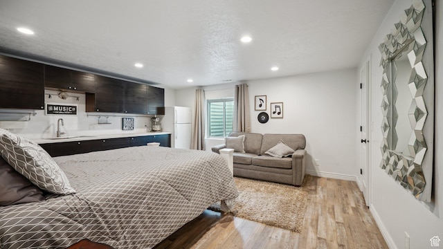 125 N 1430 E, Spanish Fork, UT 84660 - bedroom with freestanding refrigerator, light wood finished floors, wet bar, recessed lighting, and baseboards