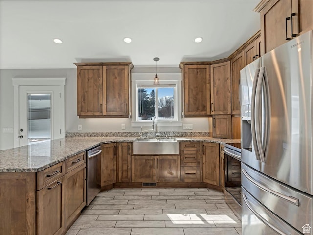 361 W 200 N, Heber City, UT 84032 - kitchen featuring appliances with stainless steel finishes, a sink, a peninsula, brown cabinets, and recessed lighting