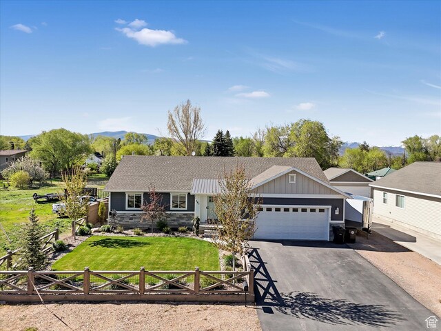 361 W 200 N, Heber City, UT 84032 - single story home featuring board and batten siding, an attached garage, asphalt driveway, a shingled roof, and a mountain view