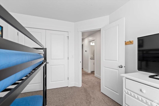 bedroom featuring light carpet and baseboards