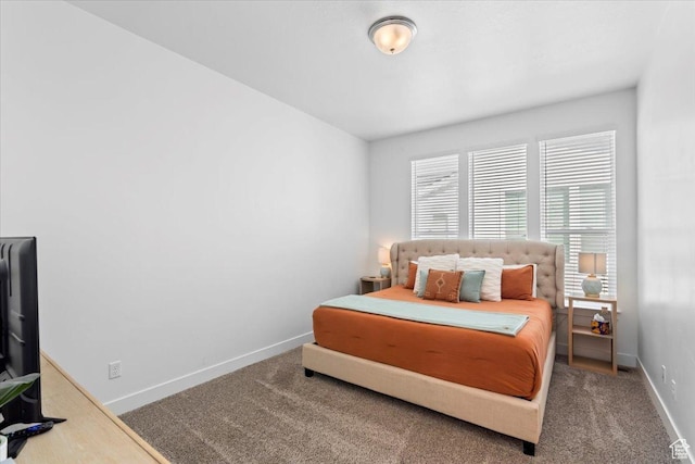 carpeted bedroom featuring baseboards
