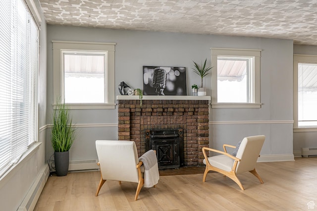 33 N 200 E, Logan, UT 84321 - sitting room with baseboards, a fireplace, wood finished floors, and baseboard heating