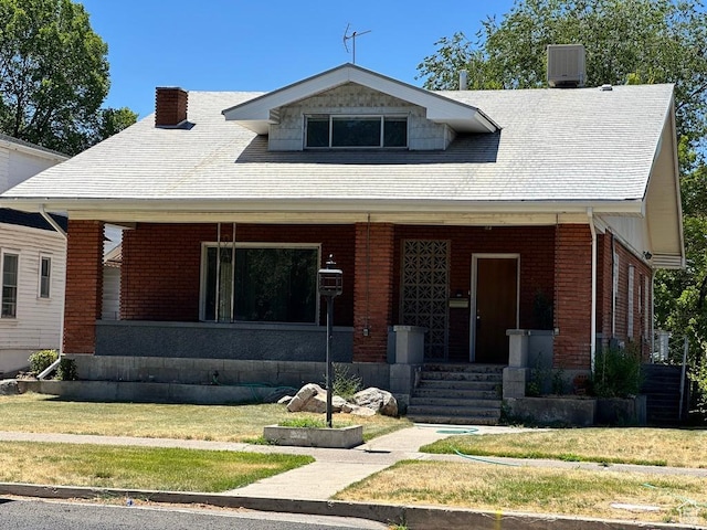 33 N 200 E, Logan, UT 84321 - bungalow-style house featuring a porch, brick siding, and a front yard