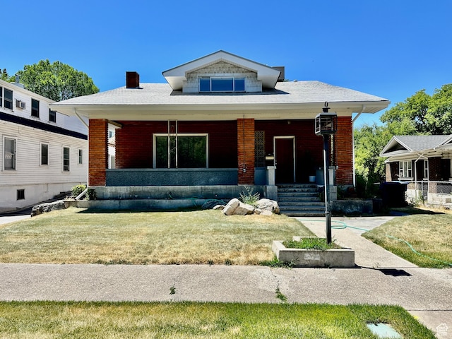 33 N 200 E, Logan, UT 84321 - bungalow-style home with a porch, brick siding, a chimney, and a front yard