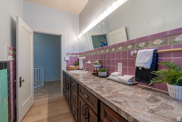 33 N 200 E, Logan, UT 84321 - bathroom featuring tile walls, wood finished floors, and vanity