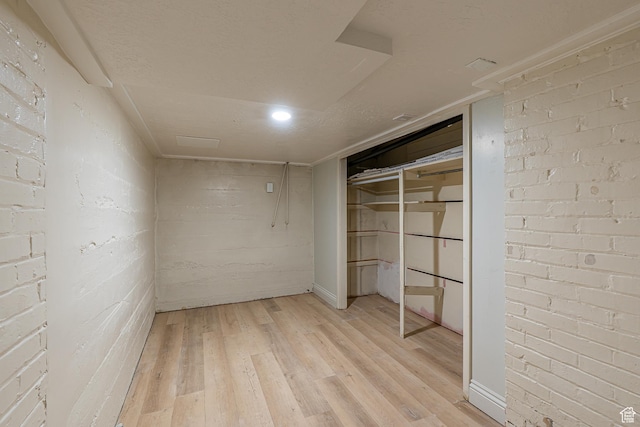 33 N 200 E, Logan, UT 84321 - unfurnished bedroom featuring brick wall and light wood-type flooring