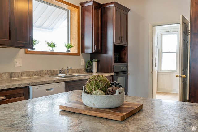 33 N 200 E, Logan, UT 84321 - kitchen featuring dishwasher, dark brown cabinetry, a sink, and oven