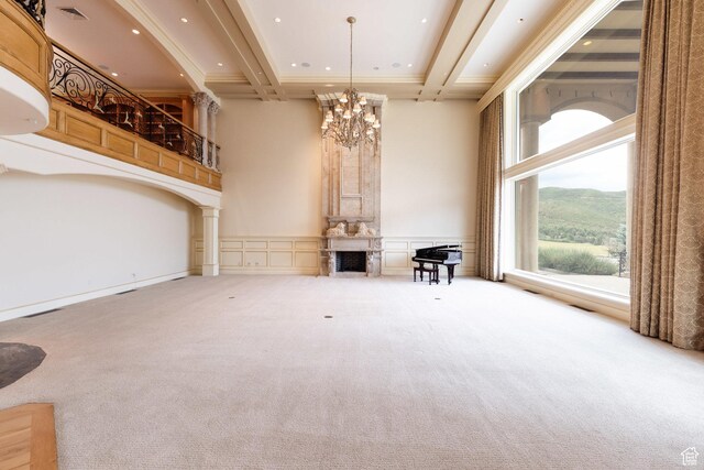 8272 Left Fork Hobble Creek Rd, Springville, UT 84663 - unfurnished living room with beam ceiling, a notable chandelier, a fireplace, and a towering ceiling