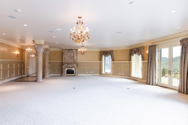 8272 Left Fork Hobble Creek Rd, Springville, UT 84663 - unfurnished living room featuring crown molding, wainscoting, an inviting chandelier, a decorative wall, and ornate columns