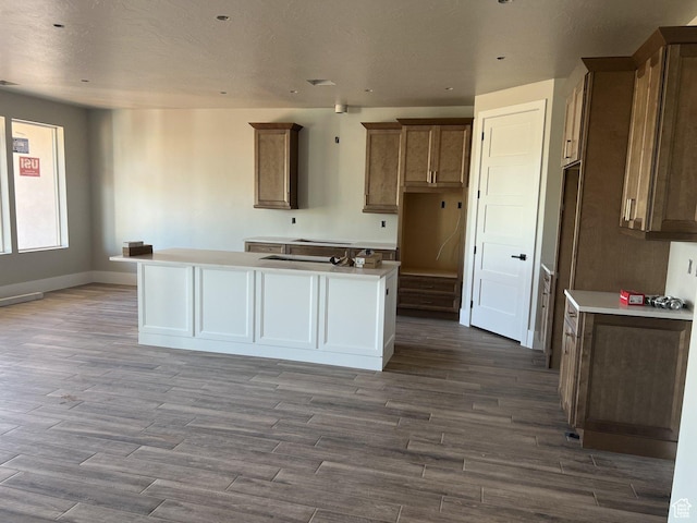 4810 W 1930 S, Hurricane, UT 84737 - kitchen featuring a center island, wood finished floors, baseboards, and brown cabinetry