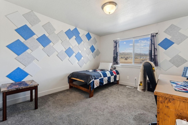 carpeted bedroom with baseboards and a textured ceiling