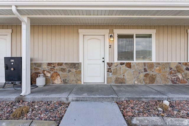 property entrance featuring stone siding