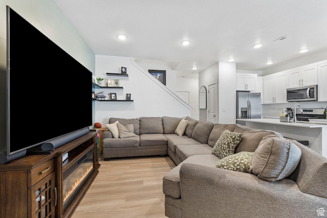 899 N 1330 E, Spanish Fork, UT 84660 - living area featuring recessed lighting, visible vents, light wood-style floors, and stairs