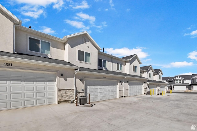 899 N 1330 E, Spanish Fork, UT 84660 - townhome / multi-family property featuring stucco siding, driveway, stone siding, a residential view, and an attached garage