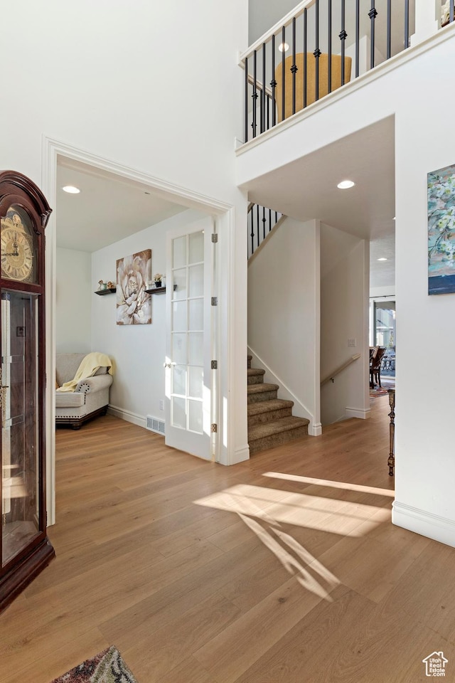 1251 N 2525 W, Clinton, UT 84015 - interior space featuring wood finished floors, visible vents, baseboards, a high ceiling, and stairs