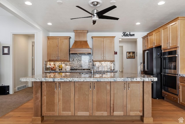1251 N 2525 W, Clinton, UT 84015 - kitchen with premium range hood, visible vents, a ceiling fan, stainless steel double oven, and high end black fridge