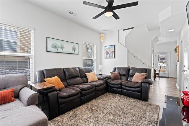 14488 S Stone Stream St W, Herriman, UT 84096 - living room featuring visible vents, stairs, a ceiling fan, and wood finished floors