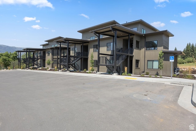 3884 N 4975 E Unit B207, Eden, UT 84310 - view of building exterior with stairs and a mountain view