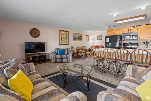 1845 W Canyon Dr S Unit 1610, St George, UT 84770 - living area featuring light carpet, visible vents, and a textured ceiling