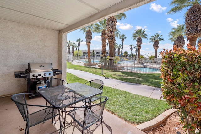1845 W Canyon Dr S Unit 1610, St George, UT 84770 - view of patio / terrace with outdoor dining area, area for grilling, fence, and a community pool