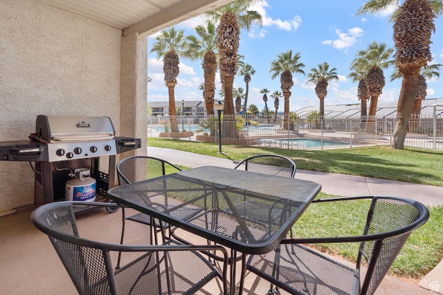 1845 W Canyon Dr S Unit 1610, St George, UT 84770 - view of patio with a community pool, a grill, outdoor dining space, and fence