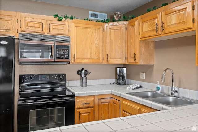 1845 W Canyon Dr S Unit 1610, St George, UT 84770 - kitchen featuring black appliances, visible vents, and a sink